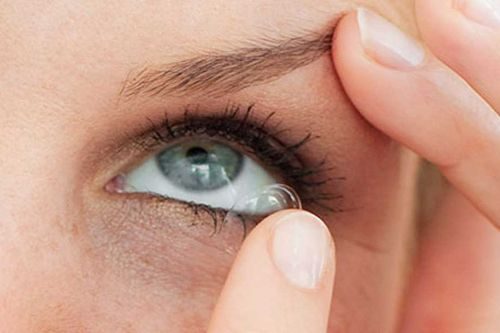 A contact lens being placed on the eye
